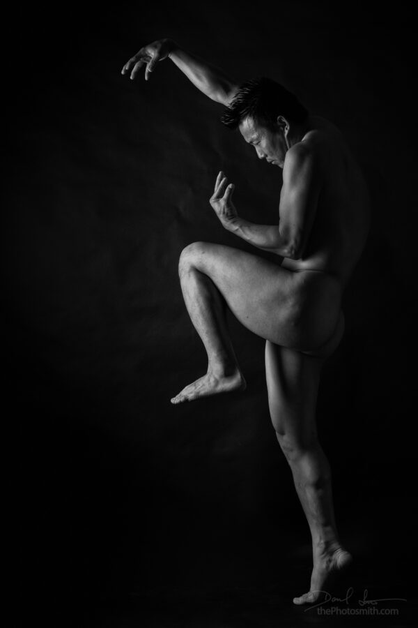 post tensioning - Vinny Miller standing nude in an athletic pose in the studio by The PhotoSmith
