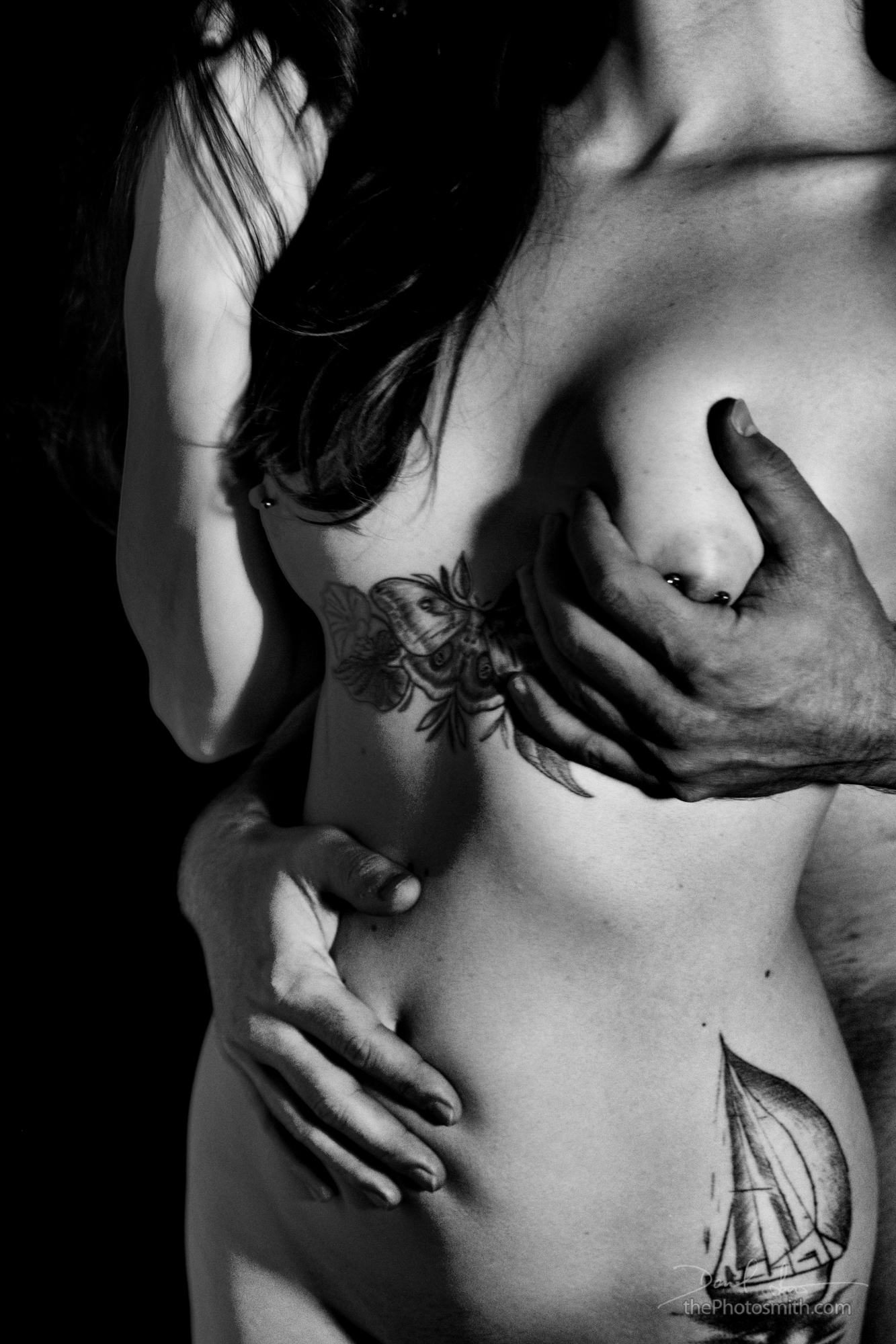 a man's hands squeeze a breast